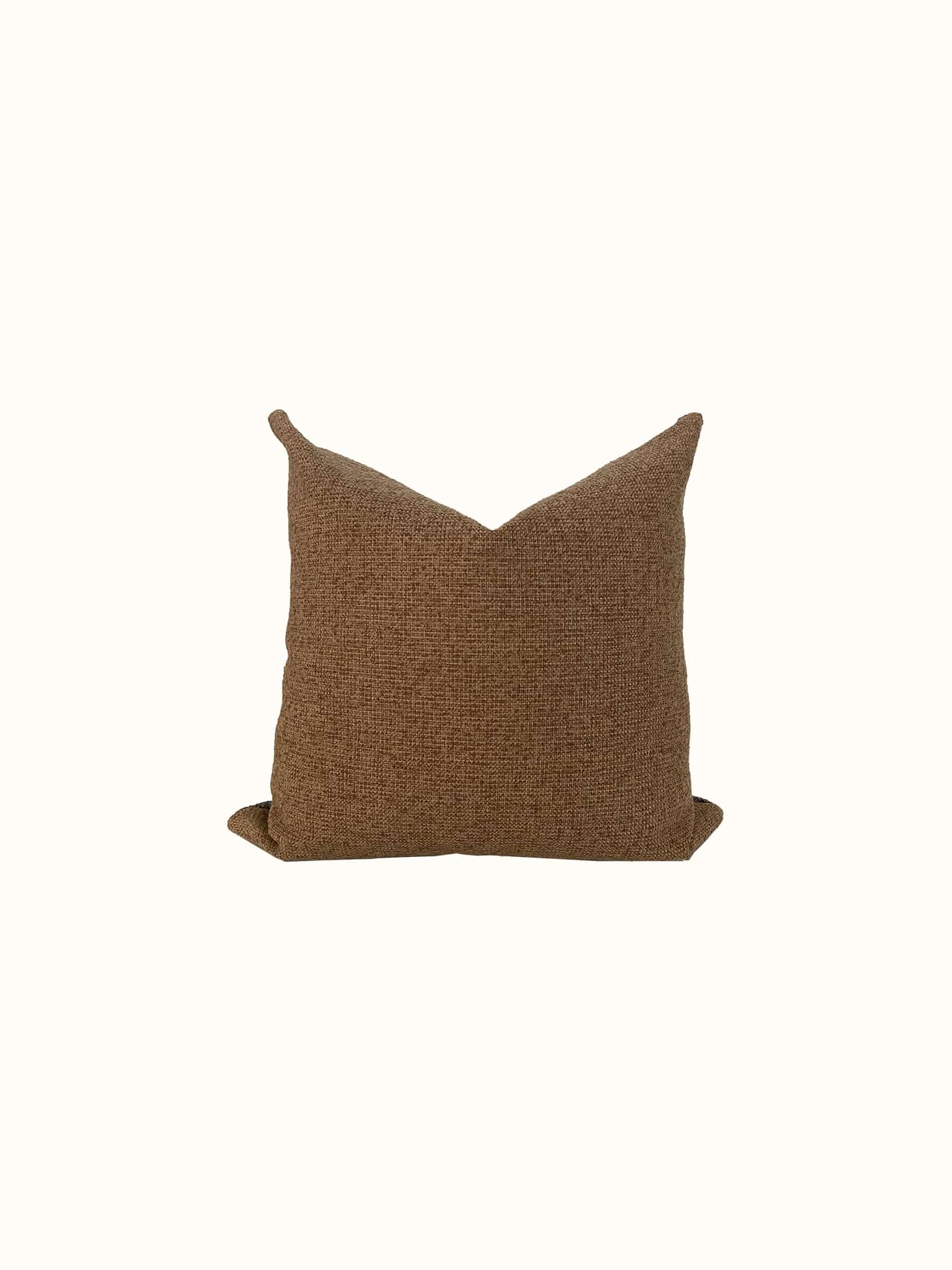 A low-pile boucle throw pillow cover in sand tan color brings a midcentury modern flair at Cielle Home