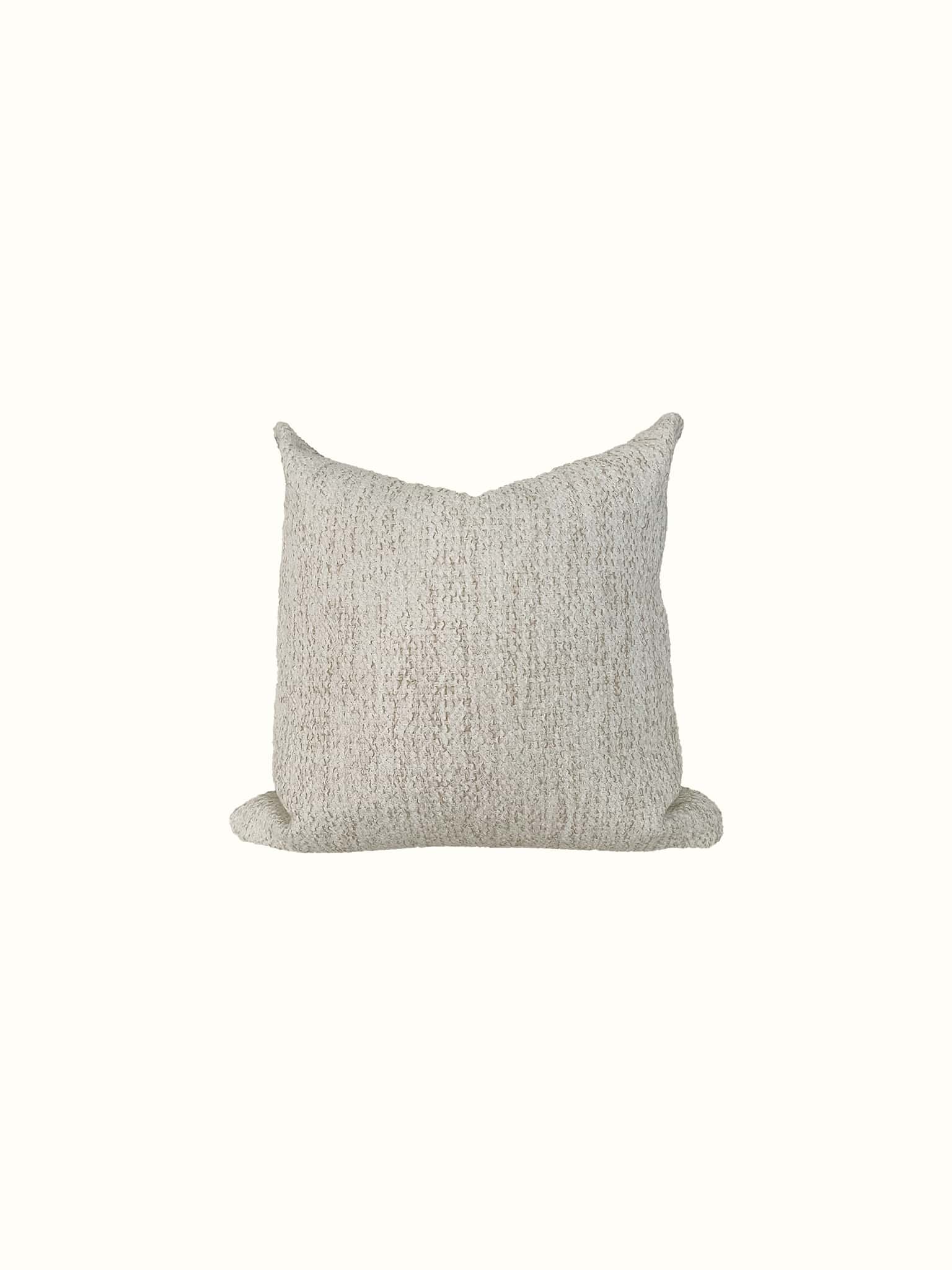 A neutral wheat colored boucle square pillow at Cielle Home
