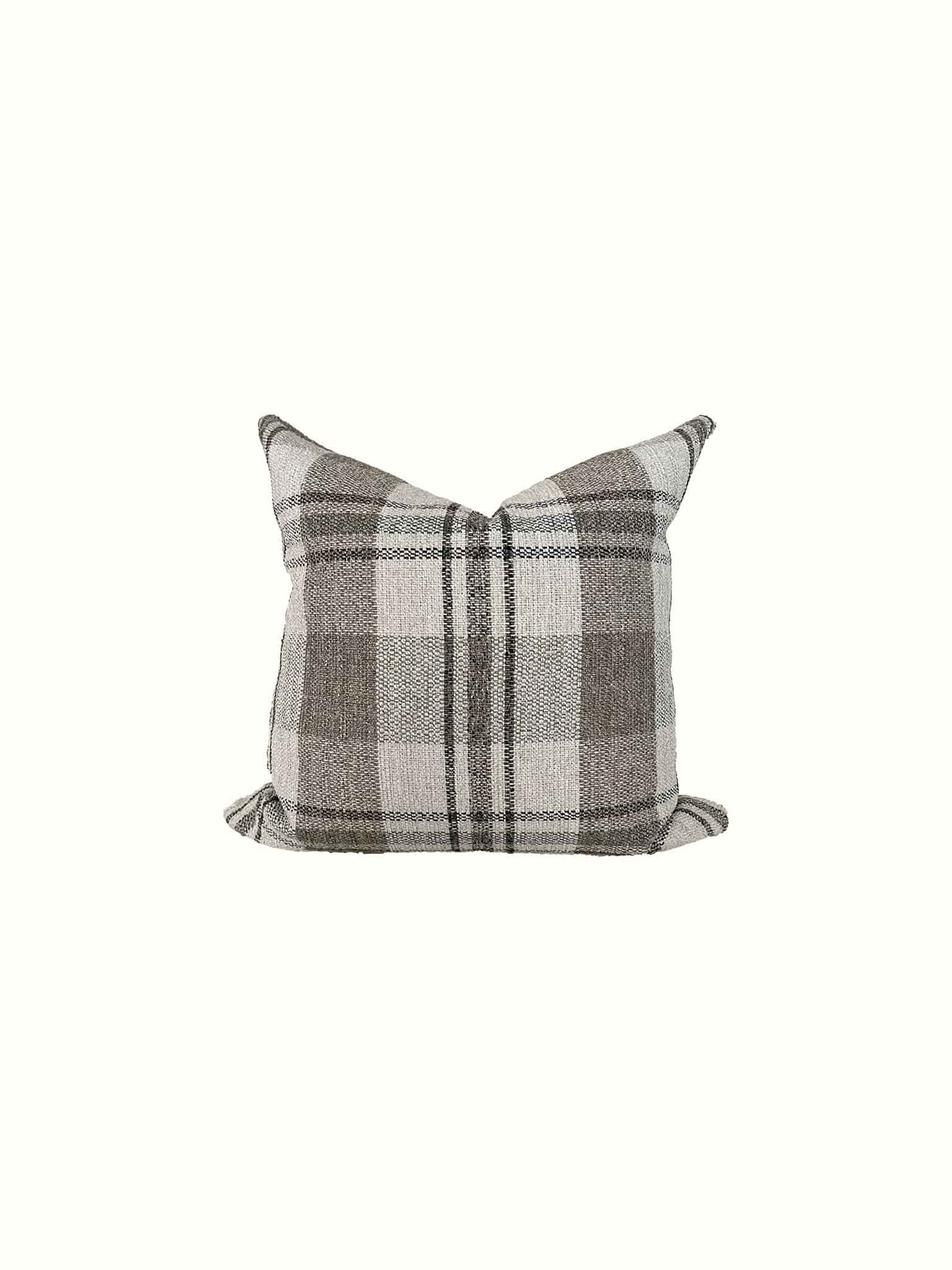 A plaid throw pillow in neutral tones gives a versatile update at Cielle Home 