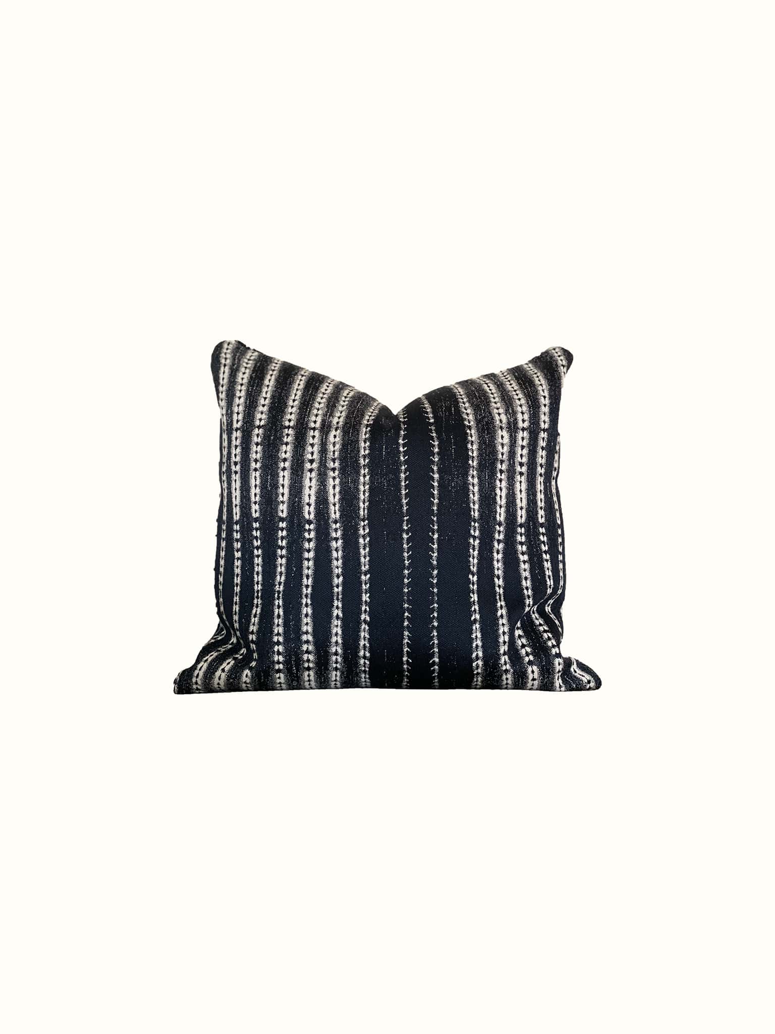 A modern class unbalanced striped throw pillow in dark blue indigo and white makes a statement piece at Cielle Home