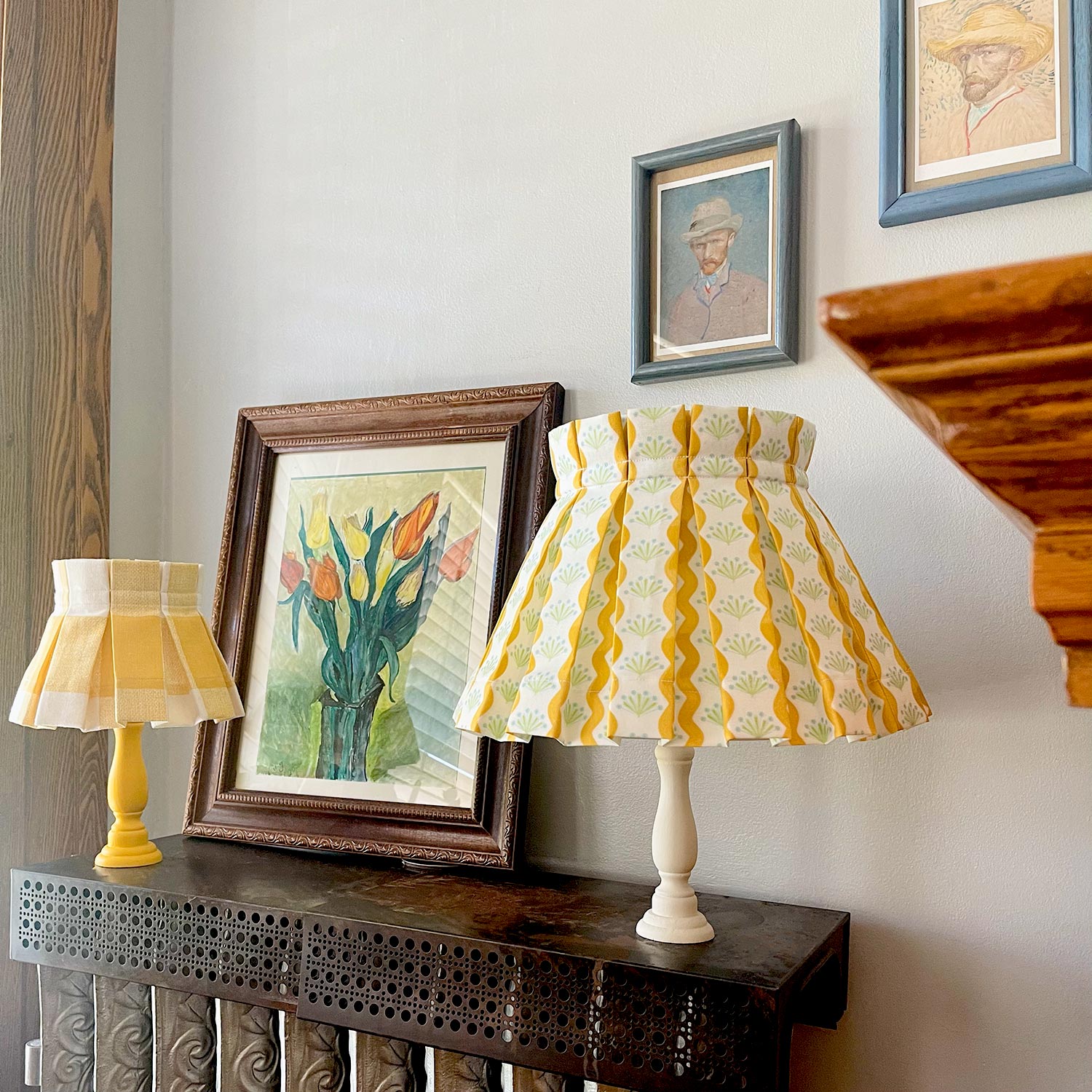 cute floral pattern yellow plaid lampshades with van gogh paintings in the back.