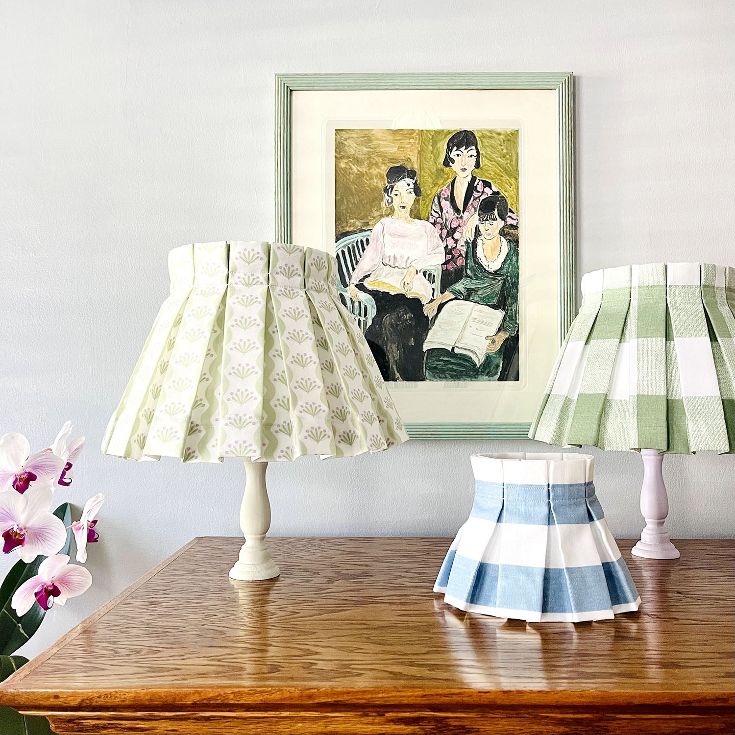 Cute lampshades in green floral scallops, green plaid, and blue and white stripes with a painting from Matisse