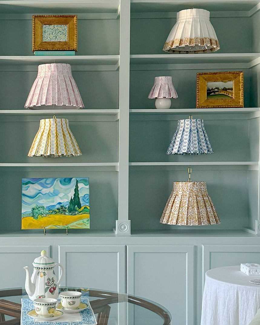 Shelves with decorative lamps and paintings in a room setting
