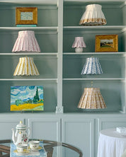 Shelves with decorative lamps and paintings in a room setting